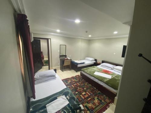 a small room with two beds and a mirror at Al Nahda Urban Company Residential Units in Jeddah