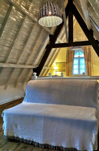 a bedroom with a large bed in a attic at Old Bruges B&B in Bruges
