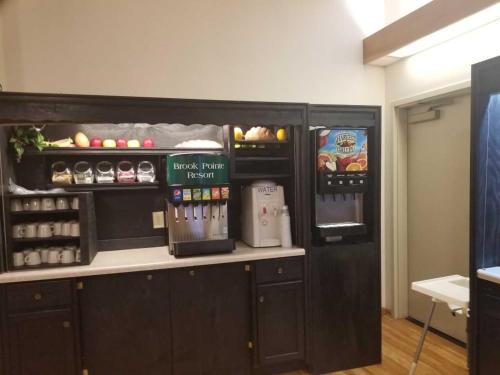 a kitchen with a counter and a refrigerator at Brook Pointe Resort in Syracuse