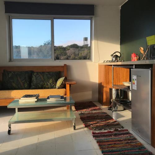 a living room with a couch and a table at Tunquen Magico in Tunquen