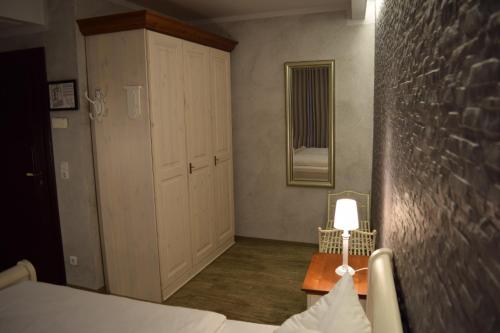 a bedroom with a bed and a lamp on a table at Hotel Arte Vida OHG in Spremberg