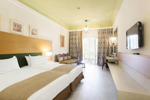 Un ou plusieurs lits dans un hébergement de l'établissement Hotel Riu Tikida Palmeraie - All Inclusive