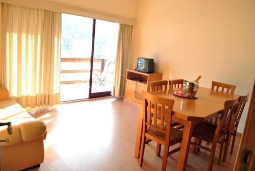 a dining room with a table and chairs and a television at Alojamento das Caldas in Caldas de Aregos