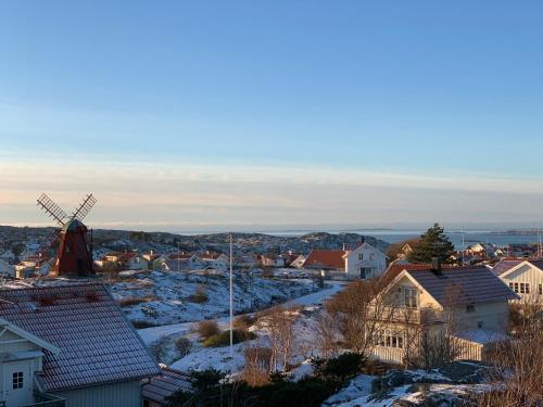 a town with a windmill and a snow covered city at Mollösunds Wärdshus in Mollösund