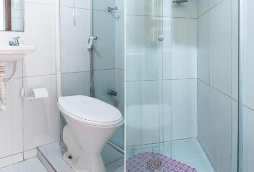 a bathroom with a toilet and a glass shower at Pousada Cor e Arte - Pelourinho in Salvador