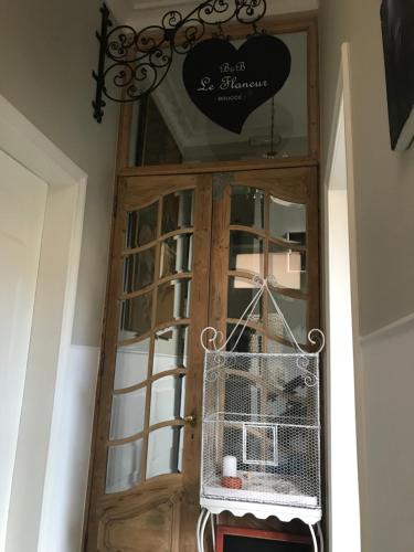 a wooden door with a bird cage in front of it at B&B Le flaneur in Bruges