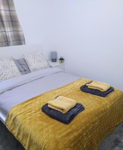 a bedroom with a bed with two towels on it at Sigma Central Apartment 2 in North Shields