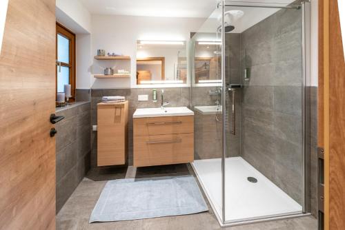 a bathroom with a shower and a sink at LakeSide Appartments in Goldegg