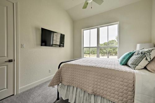 a bedroom with a bed with a tv and a window at Cascada at Canyon Lake about 1 Mi to Wedding Venues! in Spring Branch