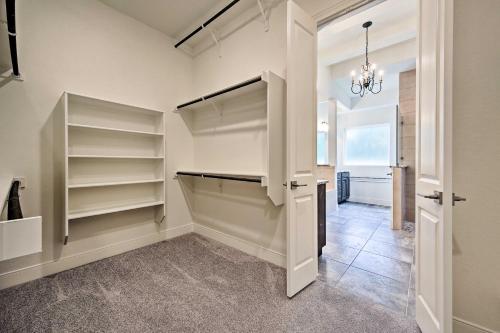 a walk in closet with white shelves and a chandelier at Cascada at Canyon Lake about 1 Mi to Wedding Venues! in Spring Branch
