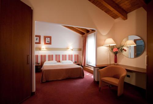 Posteľ alebo postele v izbe v ubytovaní Eurohotel Palace Maniago