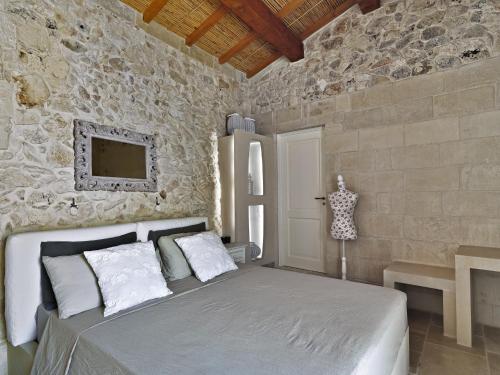Ένα ή περισσότερα κρεβάτια σε δωμάτιο στο Relais Masseria Capasa