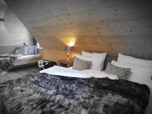 a bedroom with a large bed and a couch at WLodgeOne in Braunlage