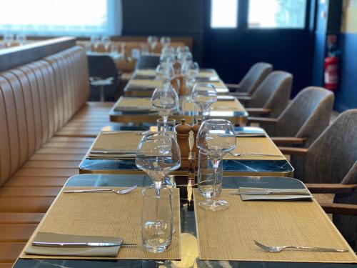a long row of tables with wine glasses on them at Hôtel Marielle in Val Thorens