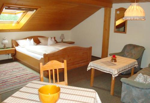 a bedroom with a bed and a table and a couch at Giglerhof in Bad Birnbach
