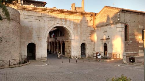 a large stone building with a large archway at La Luna nel Parco in Fano