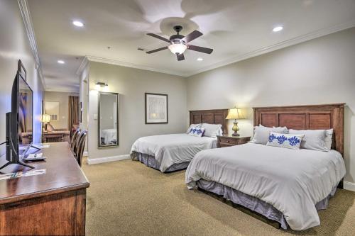 a bedroom with two beds and a flat screen tv at Resort-Style Condo on Golf Course with Private Pool! in Spring Lake