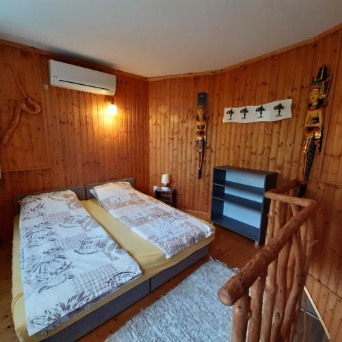 a bedroom with a bed and a television in it at Ancsi Apartmanház in Balatonlelle