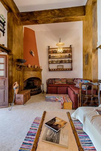 a living room with a couch and a fireplace at Hara's Traditional Detached House in Malona in Malona Village