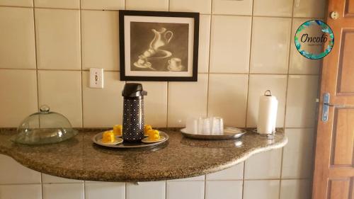 a counter top with a coffee maker and candles on it at Oncotô Palmas Hostel in Palmas