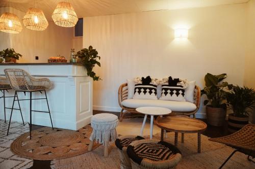 a living room with a couch and a table and chairs at Hotel La Chaumette in Privas