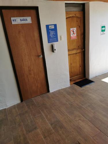a hallway with two doors and a sign that says no drugs at Hostal Luna del Mar 840-B in La Serena
