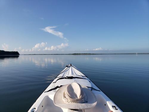 a person in a kayak on a body of water at La Casa del Alux - Adults Only in Holbox Island