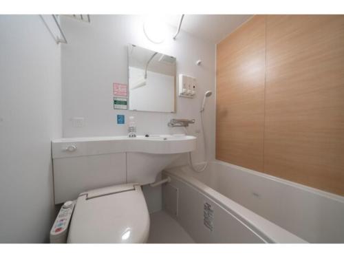 a bathroom with a toilet and a sink and a tub at R&B Hotel Sendai Higashiguchi - Vacation STAY 14642v in Sendai