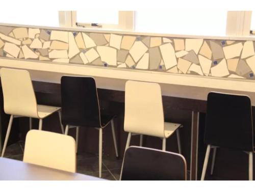 a row of chairs sitting in front of a bar at R & B Hotel Kamata Higashiguchi - Vacation STAY 14835v in Tokyo