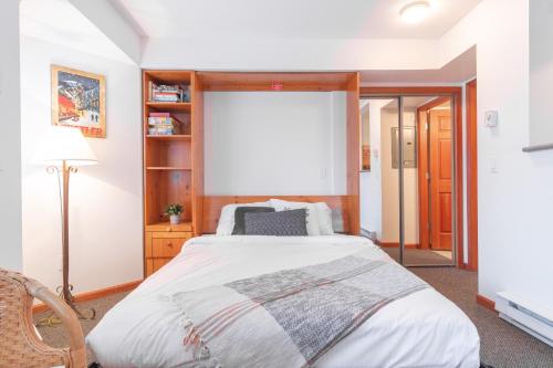a bedroom with a bed and a large window at Lagoons by Outpost Whistler in Whistler