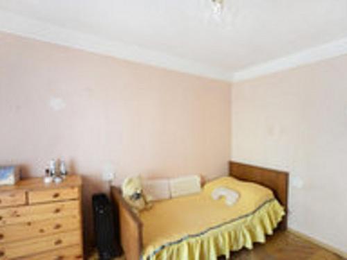 a small bedroom with a bed and a dresser at Comfortable isolated turnkey room near the subway and the International Exhibition Center in Kyiv