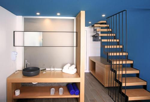 a bathroom with a staircase and a sink and a stair case at Meropi Hotel & Apartments in Malia
