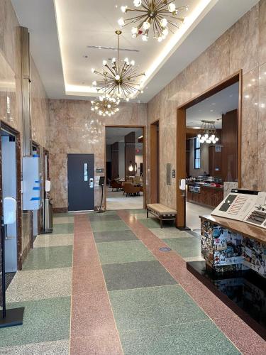 a lobby with a hallway with a room with a lobby at Hyatt Place Houston Downtown in Houston