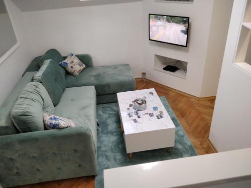 a living room with a couch and a table at Apartman Lana in Bijeljina
