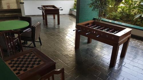 a wooden organ sitting on a tile floor next to a table at Angra Inn, Angra dos Reis - Mar, Sol e Piscina in Angra dos Reis