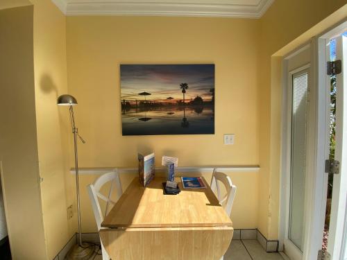 a wooden table with chairs in a room at Coral Sands Inn in Ormond Beach