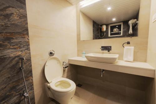 a bathroom with a toilet and a sink at Kabila Agro Tourism in Mahabaleshwar