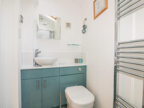 a bathroom with a sink and a toilet at Puffin Cottage in Truro