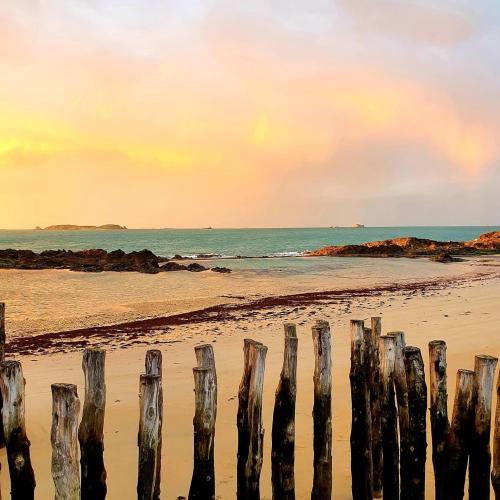 a group of wooden posts on the beach at Hôtel France et Chateaubriand in Saint Malo