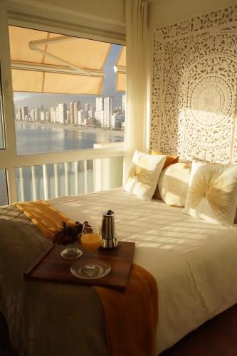 a bedroom with a bed with a view of the city at Portofino Playa in Benidorm