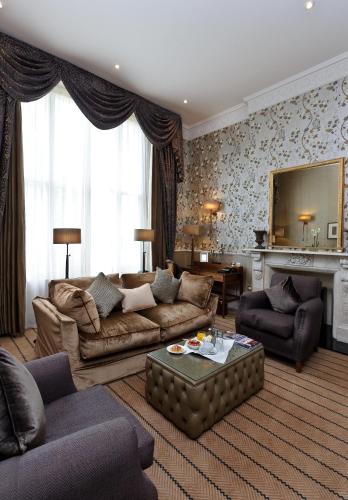 a living room with a couch and a table at The Colonnade in London