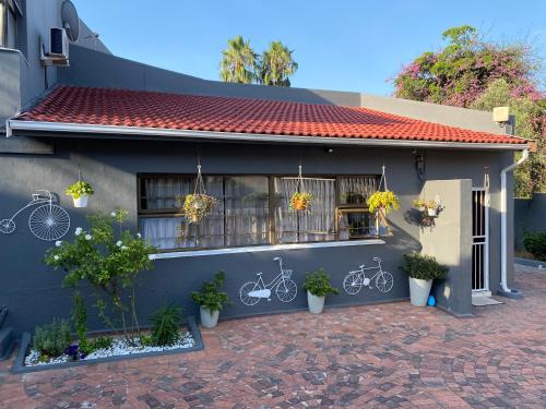 a house with a wall with drawings of bicycles on it at Marion Lodge in Johannesburg