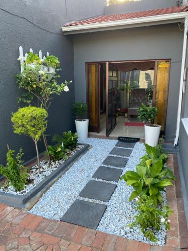 a garden with plants and a walkway at Marion Lodge in Johannesburg