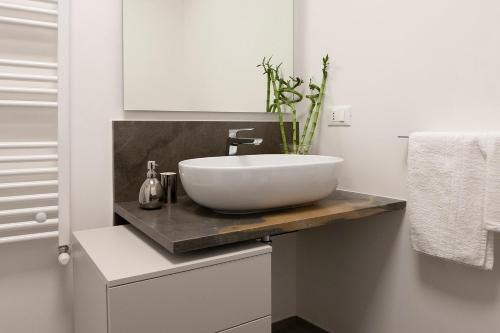 a bathroom with a white sink on a counter at Le Cupole Suites & Apartments in Trapani