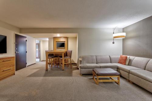 a living room with a couch and a table at Hyatt Place Minneapolis/Downtown in Minneapolis