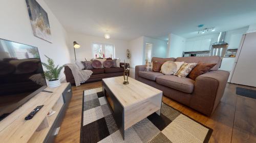 a living room with a couch and a coffee table at SRK Serviced Accommodation, 2 Bedroom Private Apartment, Business, Leisure, Contractors in Peterborough