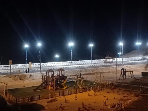 a playground at night with lights in the background at شاليهات بورتو مطروح فيو بحر Porto Matrouh Sea View Families Only in Marsa Matruh