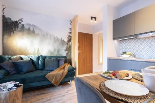 a living room with a couch and a table at Apartament "Nosal" Droga na bystre Zakopane in Zakopane