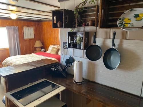 a kitchen with pots and pans hanging on the wall at Roundtop Mountain Vista - Cabins and Motel in Thermopolis