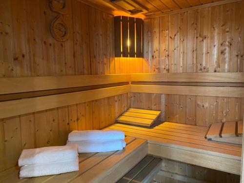 a sauna with two stacks of towels in it at Family & Business Sauna Apartments Klonowa nad Zalewem, Unikat SPA - 2 Bedroom with Private Sauna, Jacuzzi, Spectacular Terrace, Air Conditioning, Garage - The Highest Standard! in Kielce